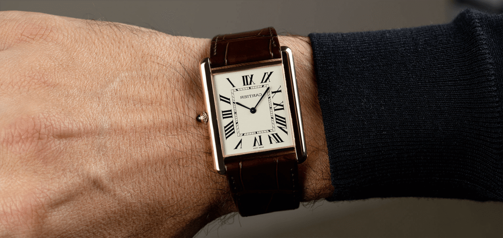 Rectangular dress watch with Roman numeral dial on wrist