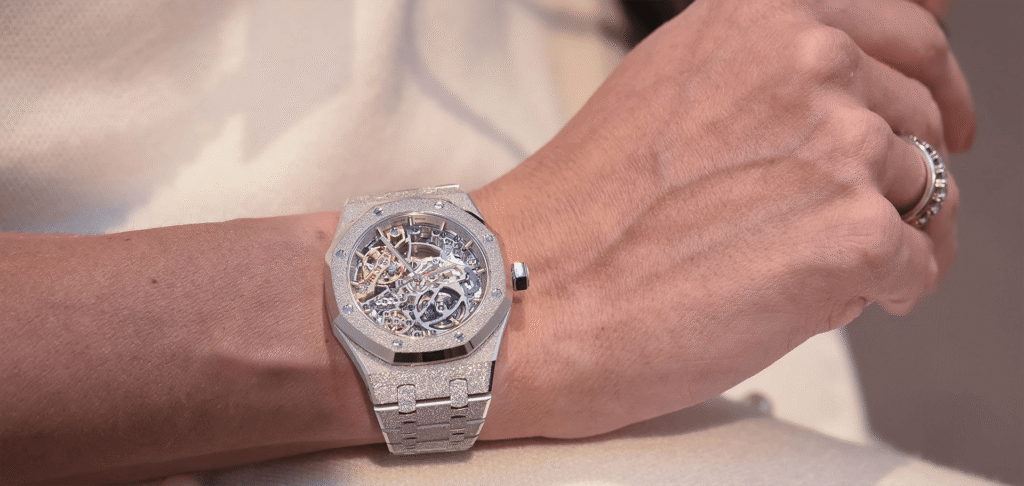 Luxury skeleton watch with diamond-set case on wrist