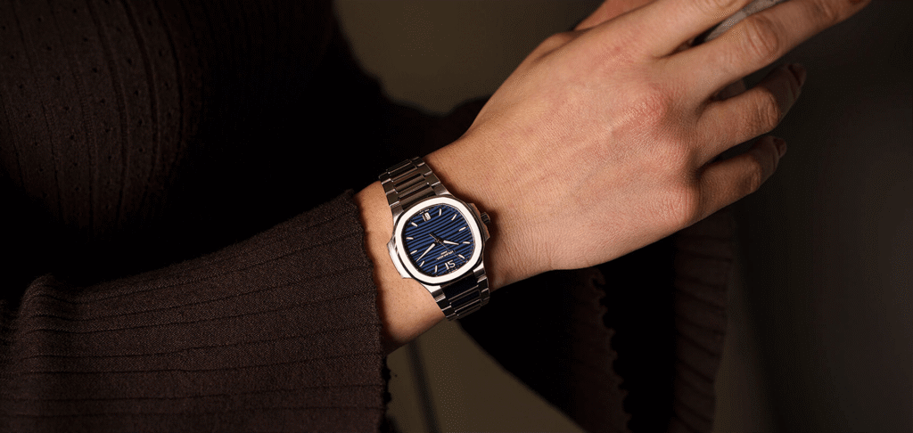 Blue dial luxury watch worn on wrist