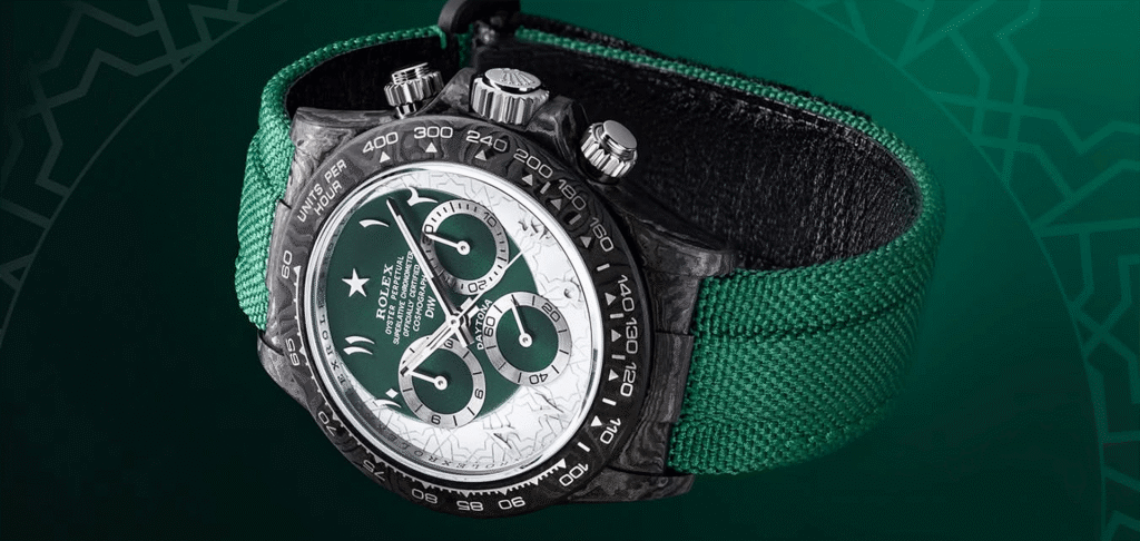 Rolex Daytona chronograph with a black case, white and green dial, and green fabric strap