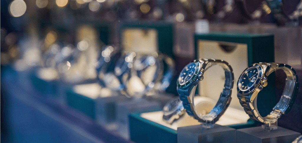 Luxury pre-owned watches displayed in a boutique showcase.